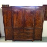 A 19th Century mahogany linen press with a pair of doors above two short and two long drawers,