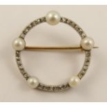 A diamond and pearl circle brooch set with full pearls and rose cut diamonds to the yellow and white