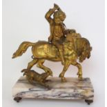 A Continental gilt bronze figure of a boy on horseback depicting a boy riding a horse with dog to