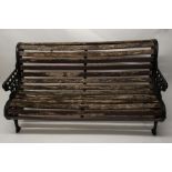 A scroll back garden seat with cast iron ends of scrolling foliage, 155cm wide