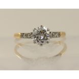 An 18ct solitaire diamond ring of approximately 0.60cts the main diamond is set in an eight claw