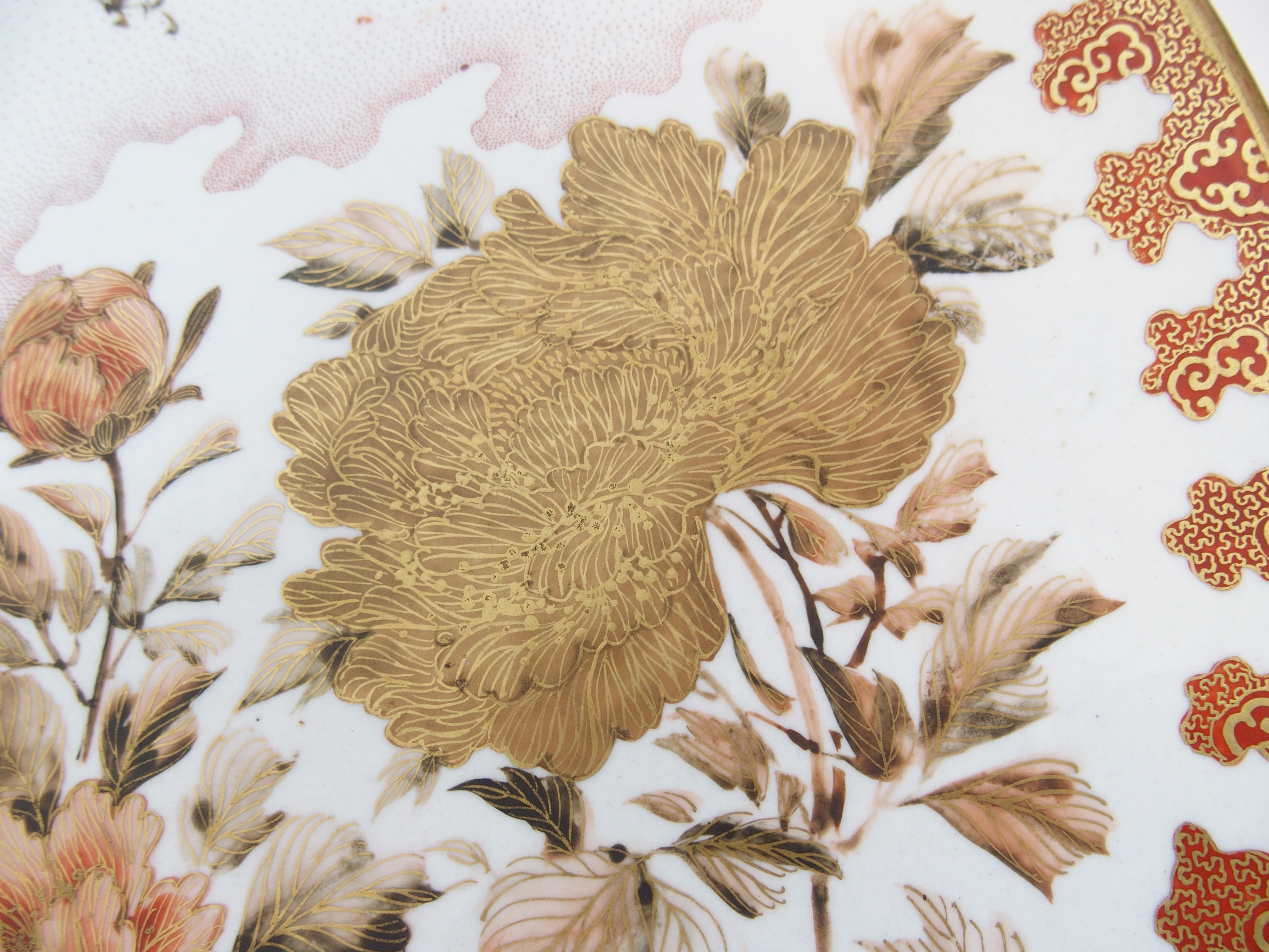 A Kutani dish painted with a peacock amongst peonies and blossoming branches within a red and gilt - Image 6 of 10