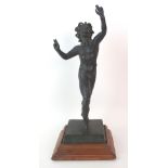 A patinated cast bronze figure of a saytr after the Antique, depicted in an active posture with arms