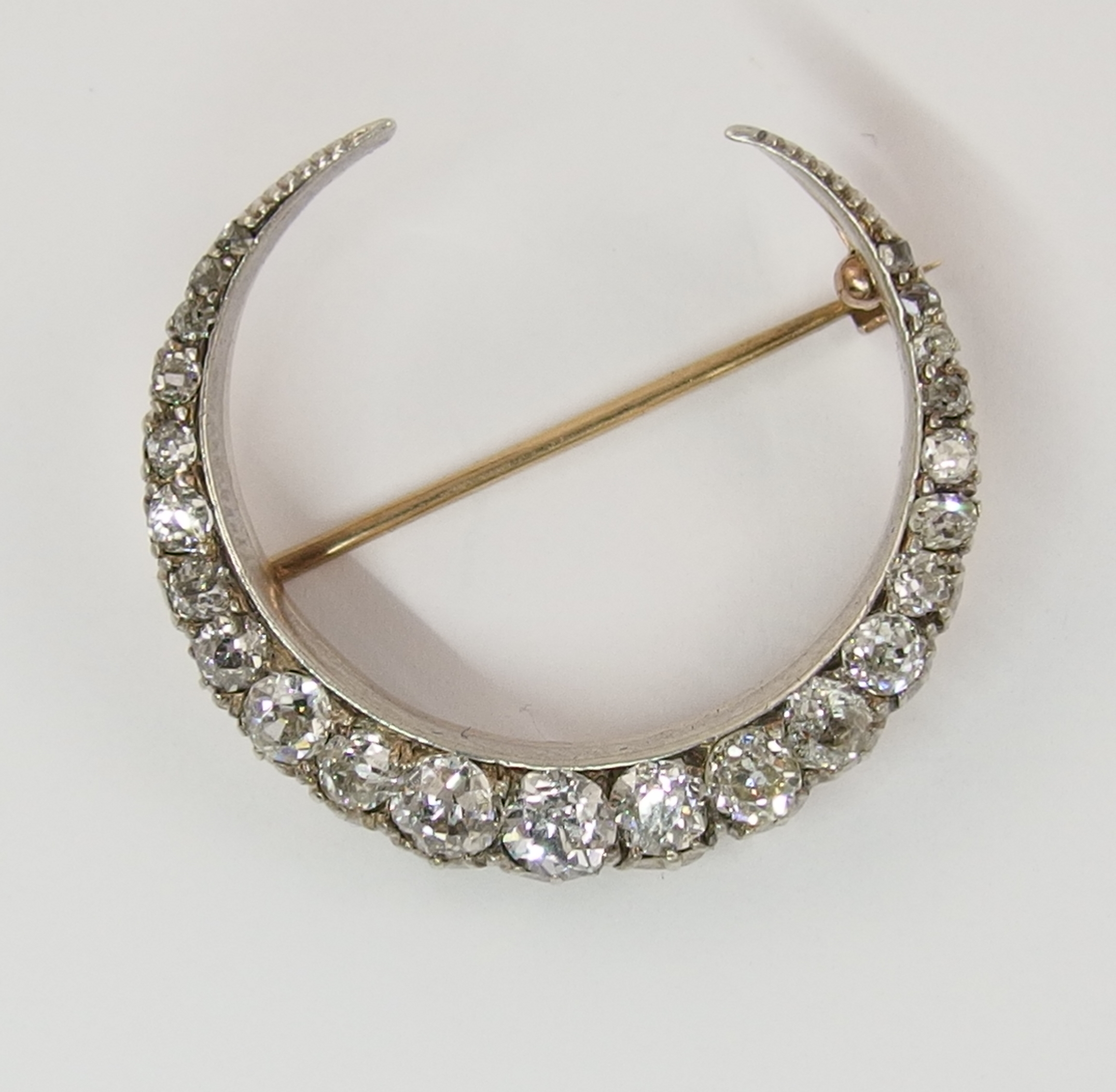 A Victorian diamond crescent moon brooch set with approximately 1.80cts of old cut diamonds in an