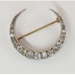 A Victorian diamond crescent moon brooch set with approximately 1.80cts of old cut diamonds in an