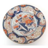 An Imari dish painted with chrysanthemum within foliate scroll cartouches, 18th/19th Century, 30cm