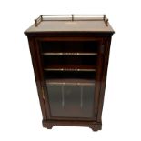 A Victorian rosewood music cabinet the three quarter brass rail above oval medallion with glazed