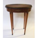 A French mahogany and brass mounted oval occasional table with pierced gallery above foliate