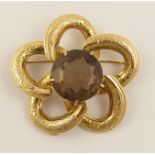 A 9ct smoky quartz set brooch in the shape of a flower hallmarked 9ct, weight 24.5gms.