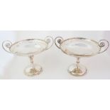 A pair of silver comports maker's marks obscure, London 1908, of circular form, the rims with