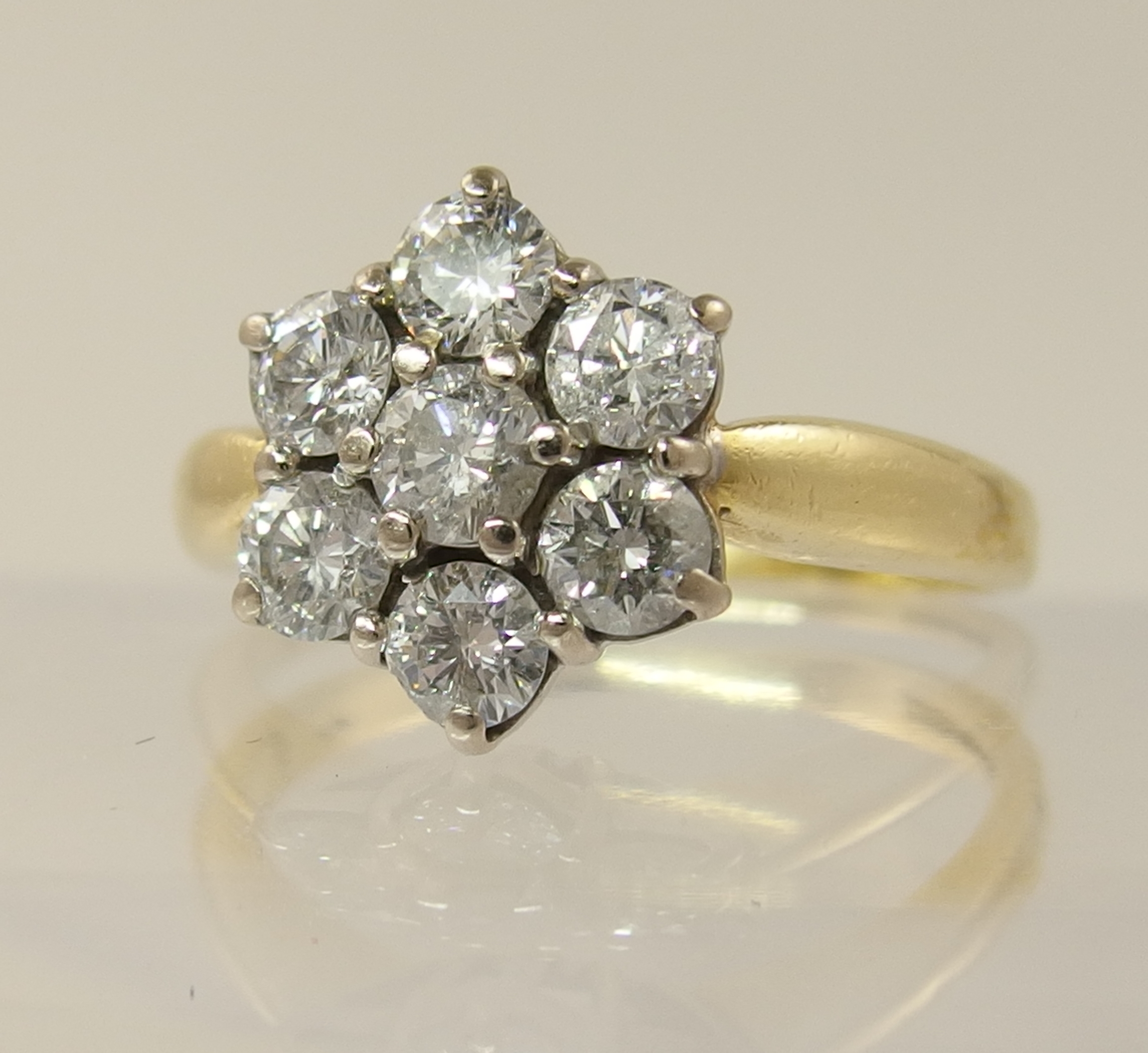 An 18ct diamond daisy cluster ring with an approximate diamond total of 0.80cts, finger size M. - Image 2 of 7