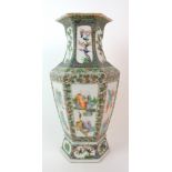 A Cantonese hexagonal tapering vase painted with panels of immortals within foliate and seed