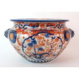 An Imari jardiniere painted with panels of foliage divided by mask handles, signed, (star crack),