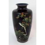 A Japanese cloisonne baluster vase decorated with a parrot perched on a maple tree above flowering