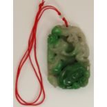 A Chinese green hard stone pendant  carved with monkeys, foo dogs and other mythical beasts and