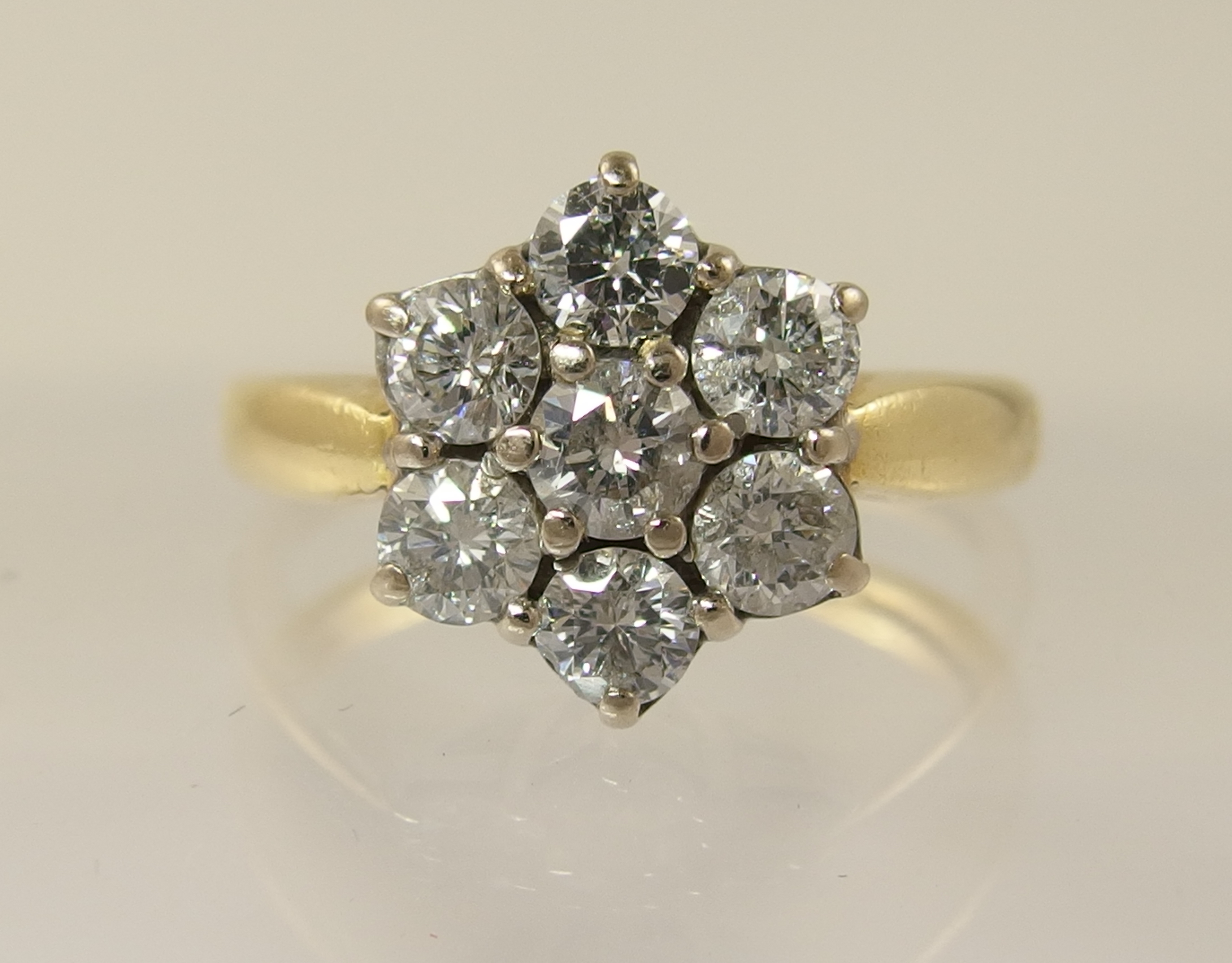 An 18ct diamond daisy cluster ring with an approximate diamond total of 0.80cts, finger size M. - Image 4 of 7