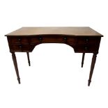 A George IV mahogany dressing table with central curved drawer flanked by a pair of short drawers on