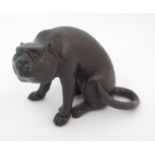 A Japanese bronze model of a large cat seated with tail curled on hind quarters, 7cm high