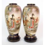 A pair of Satsuma vases painted with ladies and children in gardens and trellis divided by gilt