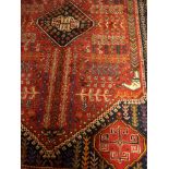 A Turkman rug on a red and green ground, 3.07 x 1.52m