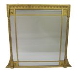 A Victorian gilt and painted wood overmantle mirror cast with stylised flowerheads and with half