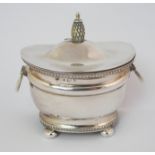 A silver tea caddy unclear maker's marks, Birmingham 1902, of rounded rectangular form with a pair