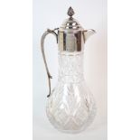 A silver topped cut glass claret jug by P H Vogel & Co., Birmingham 1989, the body pear shaped,