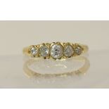 An 18ct five stone diamond ring of approximately 0.50cts combined unusually half rub over set to the