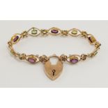 *WITHDRAWN* A 9ct rose gold Edwardian peridot and amethyst bracelet with pretty scrolled links set