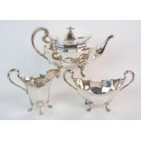 A three piece silver tea service by Lawson & Company, Glasgow 1912, of oval shape, the faceted