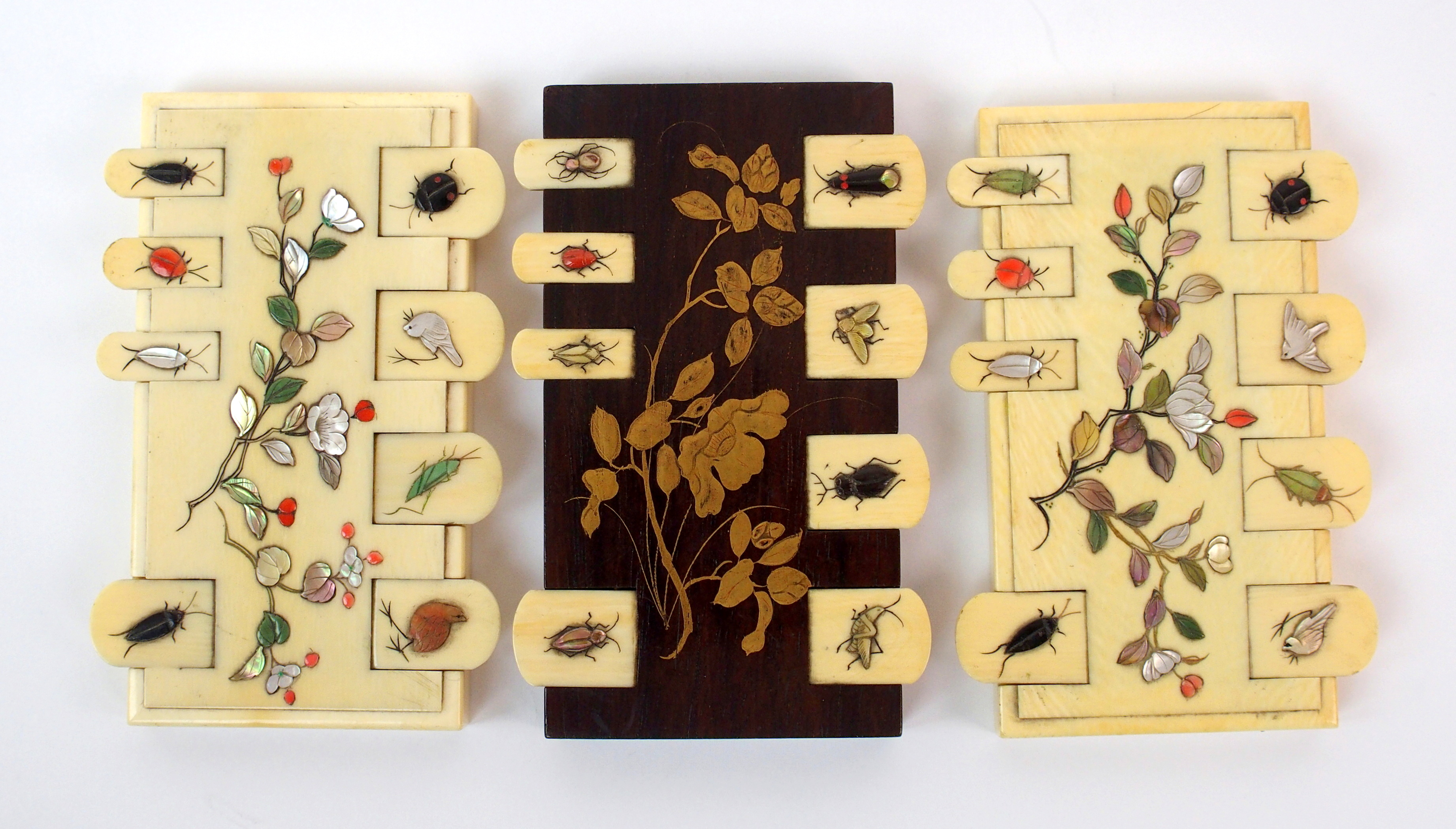 Three Japanese game counters two in the Shibiyama style decorated with insects and foliage, the