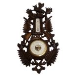 A black forest stained barometer and thermometer carved with sporting trophies, fox and foliage,