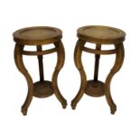 A pair of giltwood plant pedestals the circular turned stand on scroll legs joined by a stretcher,