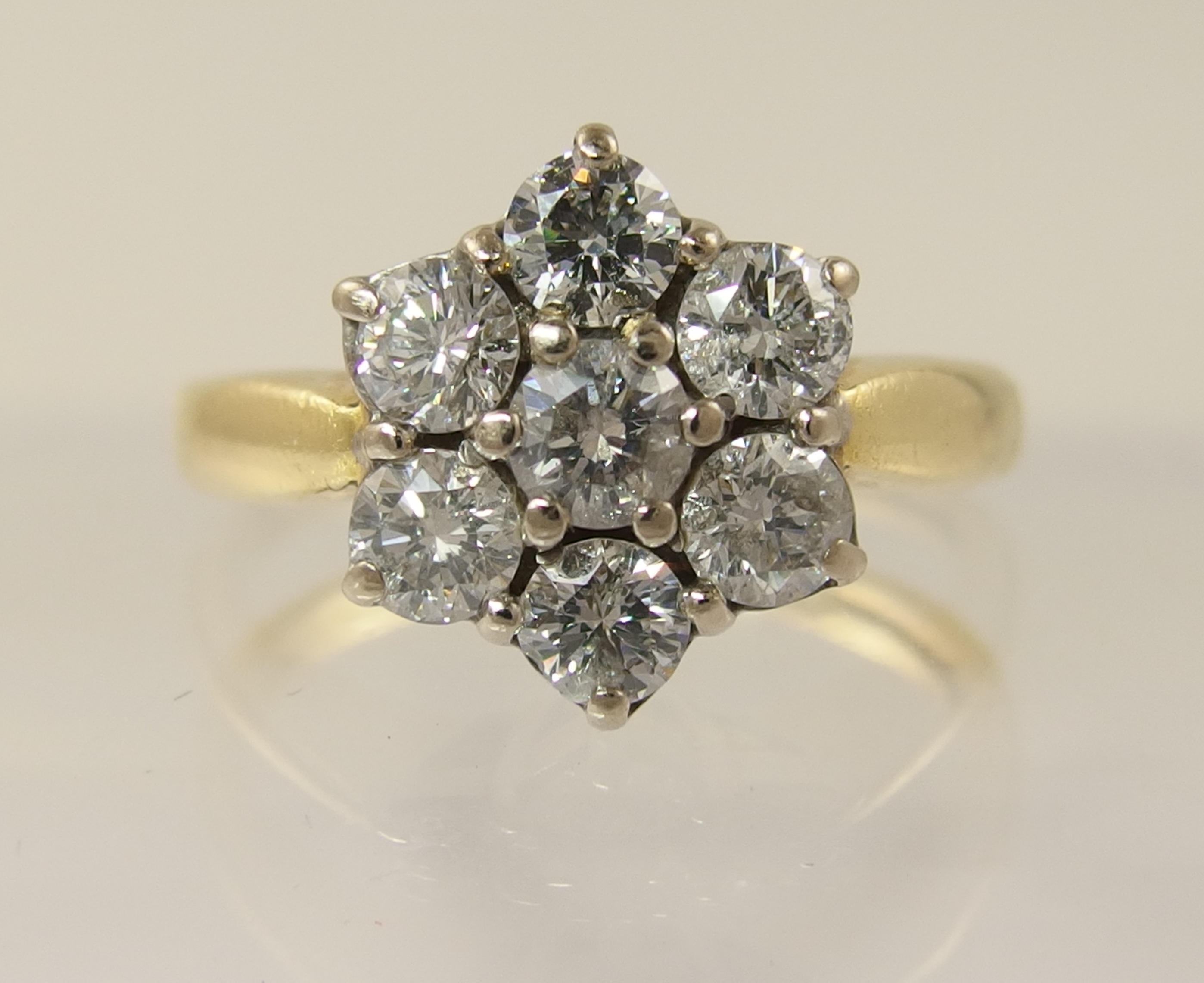 An 18ct diamond daisy cluster ring with an approximate diamond total of 0.80cts, finger size M.