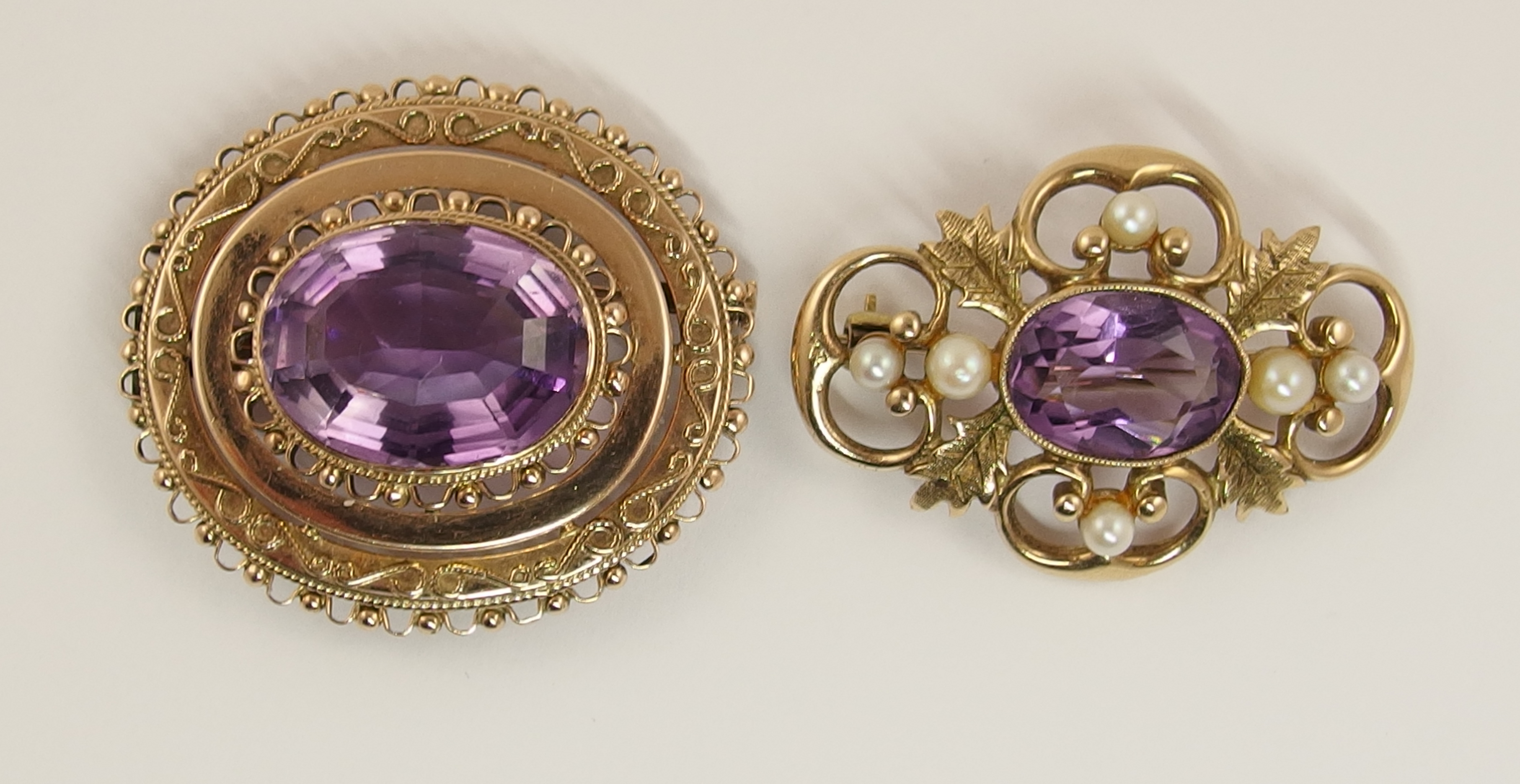 Two rose gold Victorian amethyst set brooches one is also a pendant with delicate filigree and