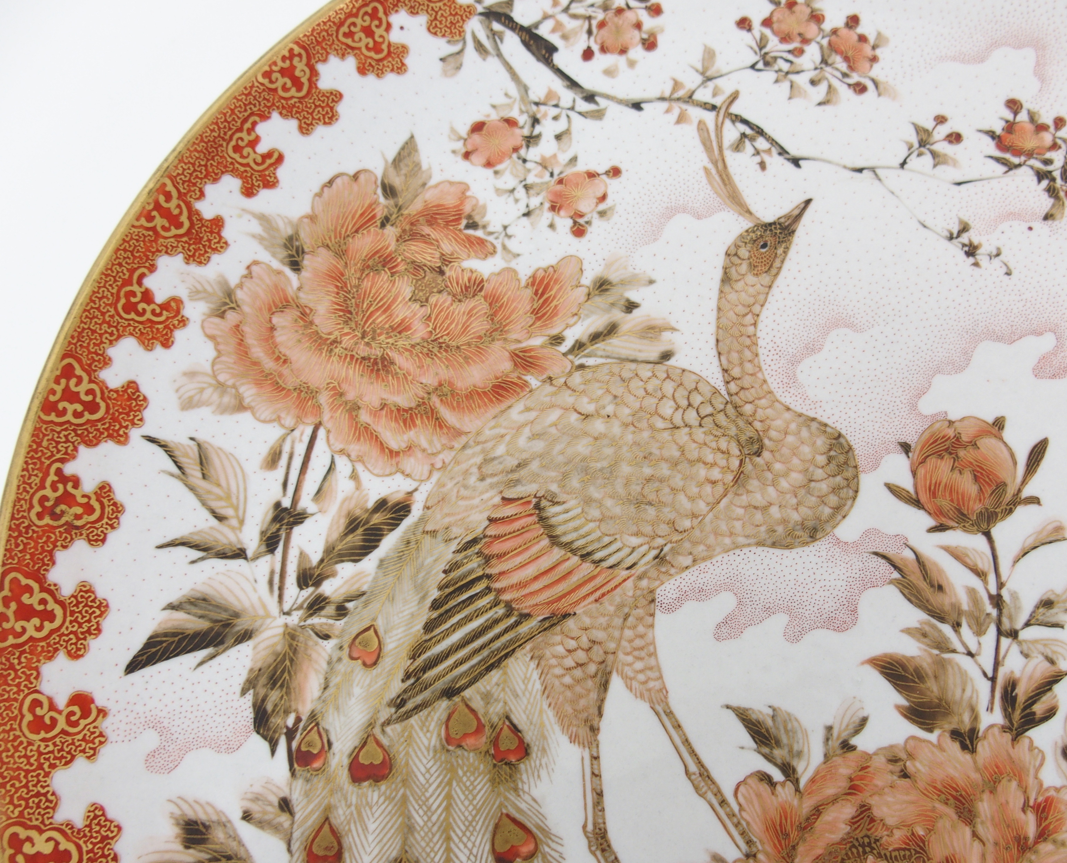 A Kutani dish painted with a peacock amongst peonies and blossoming branches within a red and gilt - Image 2 of 10
