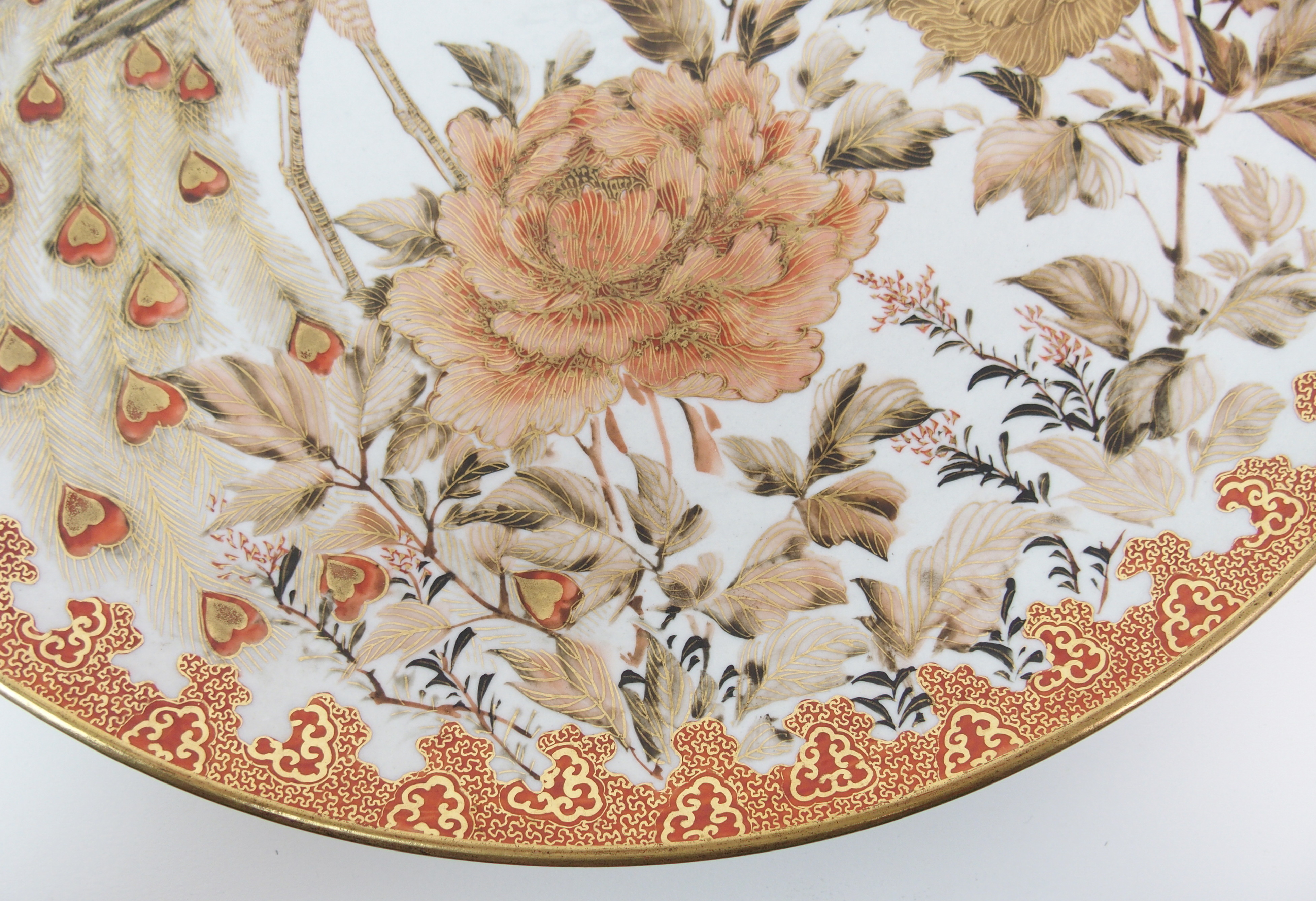 A Kutani dish painted with a peacock amongst peonies and blossoming branches within a red and gilt - Image 4 of 10