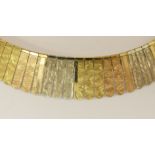 An 18ct tri colour gold collar necklace made from separate petals of red, yellow and white gold made