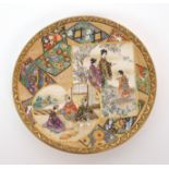 A Satsuma small dish painted with panels of figures in gardens divided by geometric floral motifs,