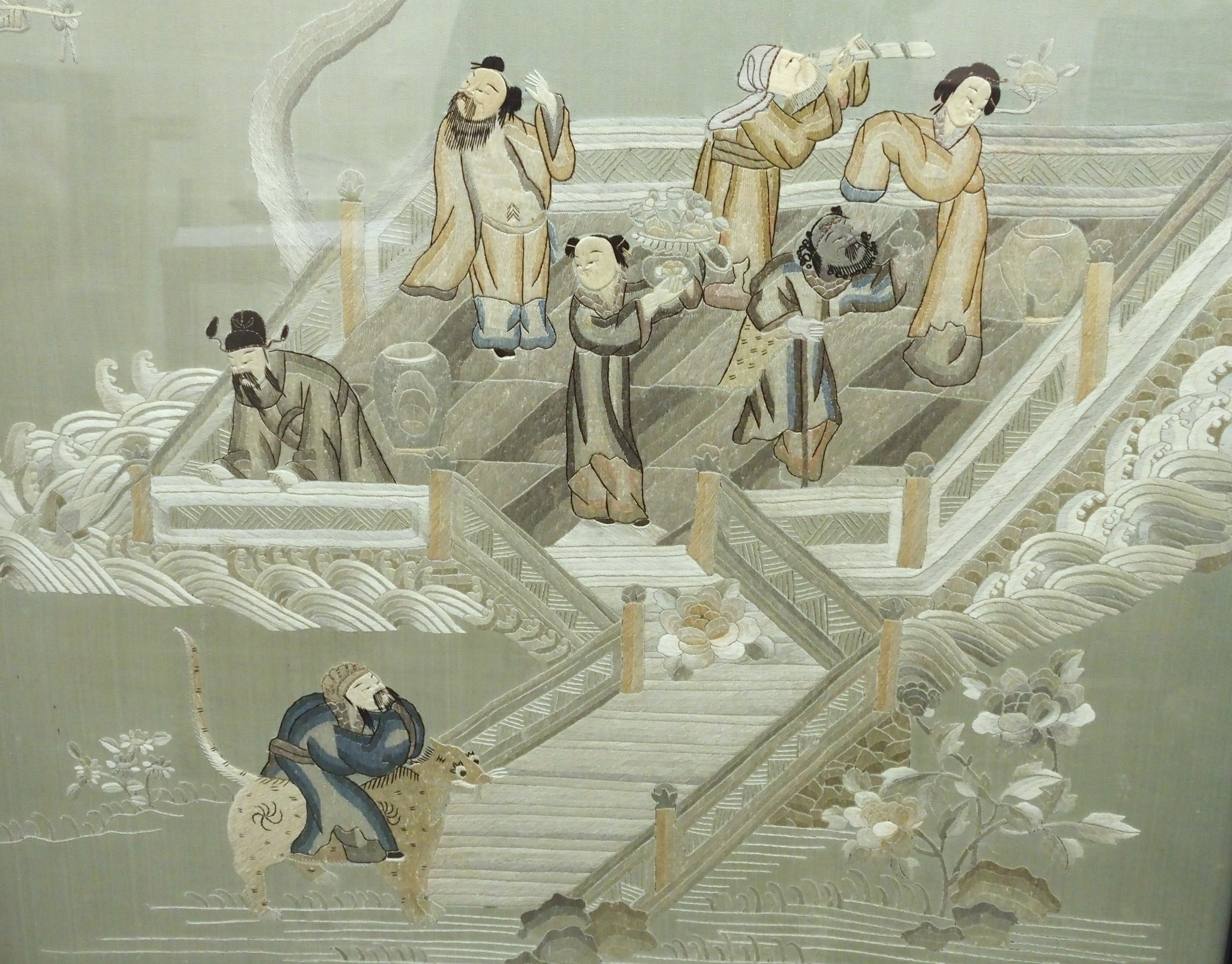 A Chinese silk embroidered picture of figures in a walled garden on an island amongst foliage, 156 x - Image 3 of 8