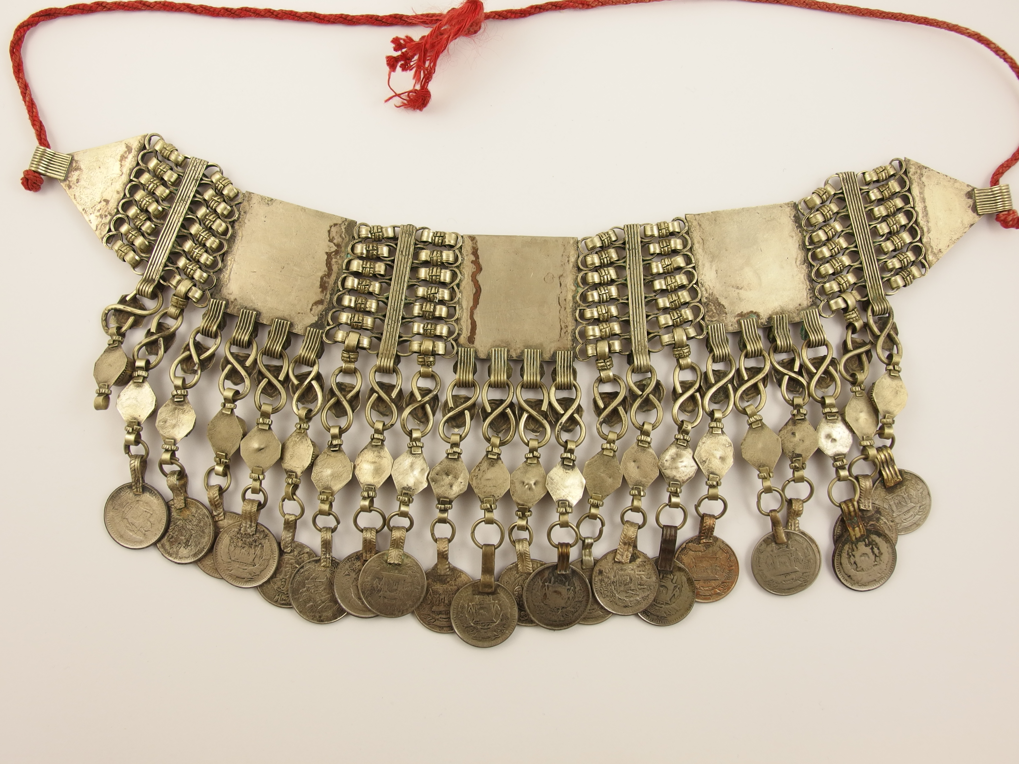 An Islamic statement necklace in white metal with foiled glazed panels, and coin pendants. - Image 2 of 2