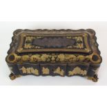 A Chinese export black and gold lacquered games box gilt with processions of figures, dragons and