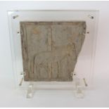 A Chinese terracotta square architectural tile carved in relief with a mule tethered to a pole