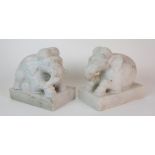 A pair of Indian elephant hardstone models each recumbent on a rectangular base, 25cm wide x 23cm