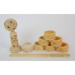 Six Cantonese ivory napkin rings decorated with dragons, 4.5cm diameter, paper knife, puzzle ball