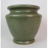 A Chinese Celadon ground jardiniere incised with large peony heads divided by leaf sprays above a