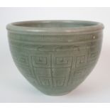 A Chinese celadon jardiniere incised with key pattern and taotie masks, signed, (hairline crack),