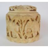 An African ivory tusk box and cover carved with a procession of elephants amongst trees, 12.5cm