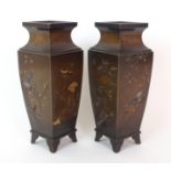 A pair of Japanese bronze square shaped vases decorated in gold and silver with panels of lilies,