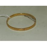 A 15 carat gold hinged bangle with brigh
